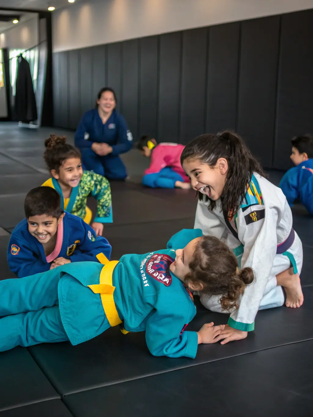 A group of children participating in a judo class, learning basic techniques and having fun under the supervision of a certified instructor.